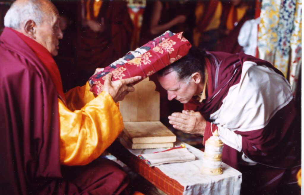 A religious ritual where a man receives a blessing with a sacred object on his head.